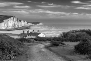 A curving path leads down to the iconic Coastguard's Cottages backed by The Seven Ssters down at Cuckmere Haven.