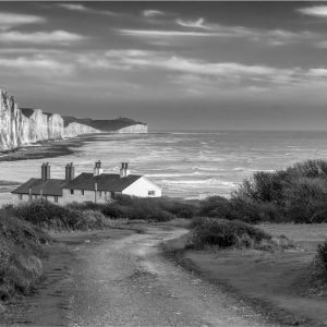 A curving path leads down to the iconic Coastguard's Cottages backed by The Seven Ssters down at Cuckmere Haven.